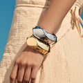 Chunky faceted bangle in gold and silver, standing upright