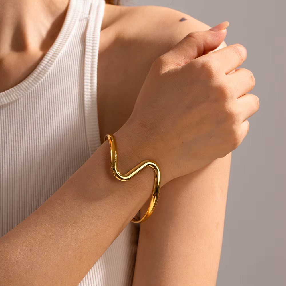Wire wave cuff bracelet worn on wrist, close-up