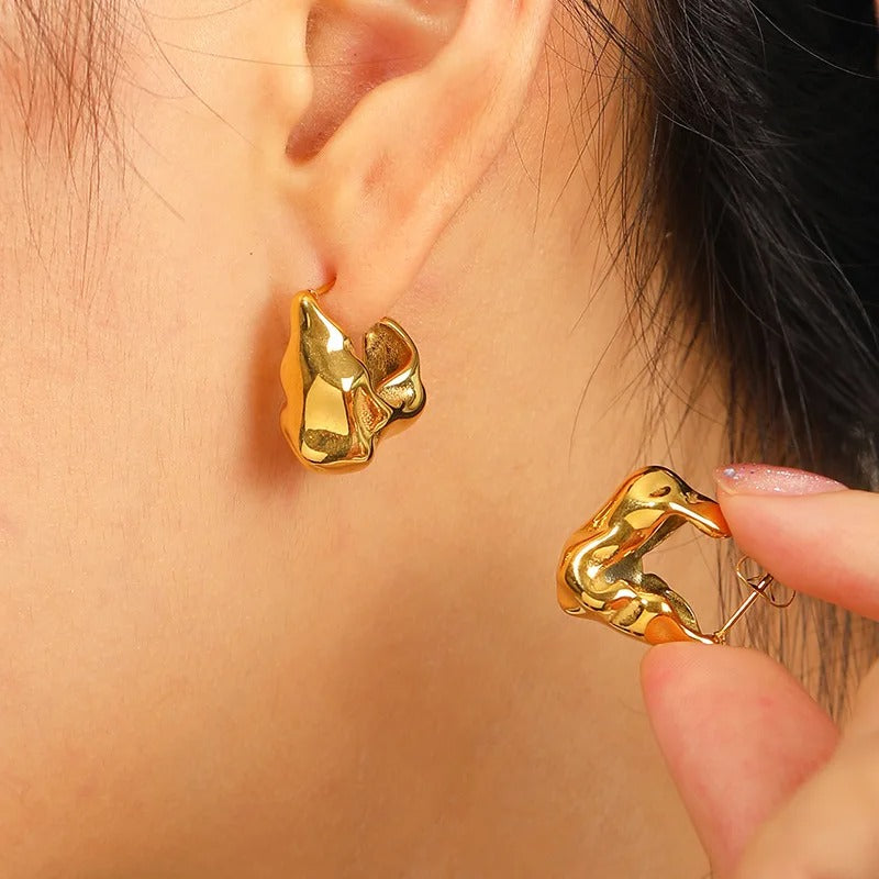 Molten textured hoop earrings worn in ear