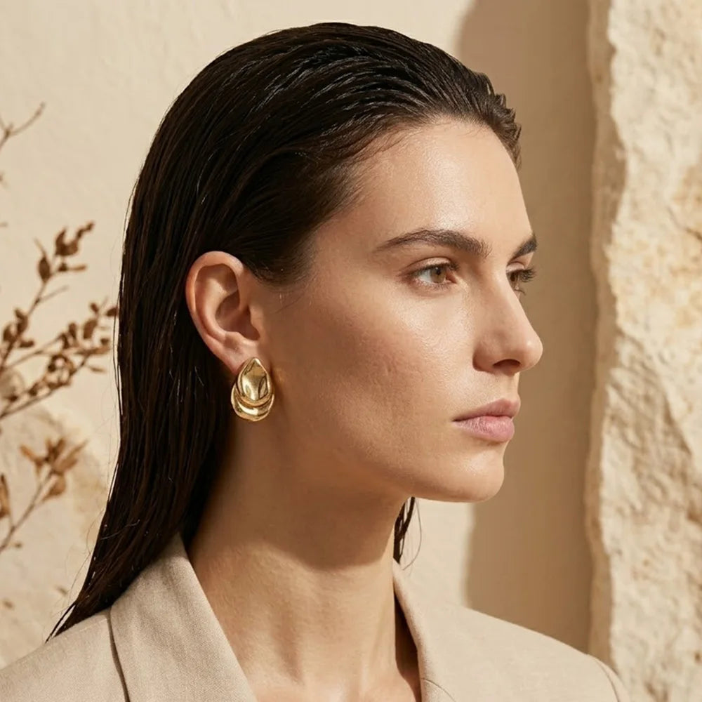 Molten Teardrop Studs, gold, worn on ear