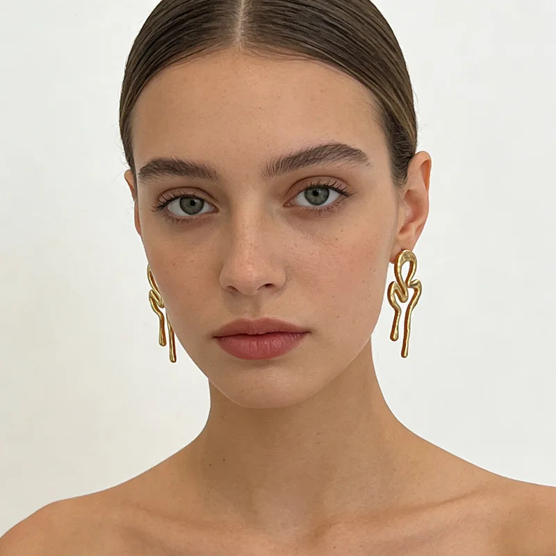 Molten squiggle earrings, front-facing worn