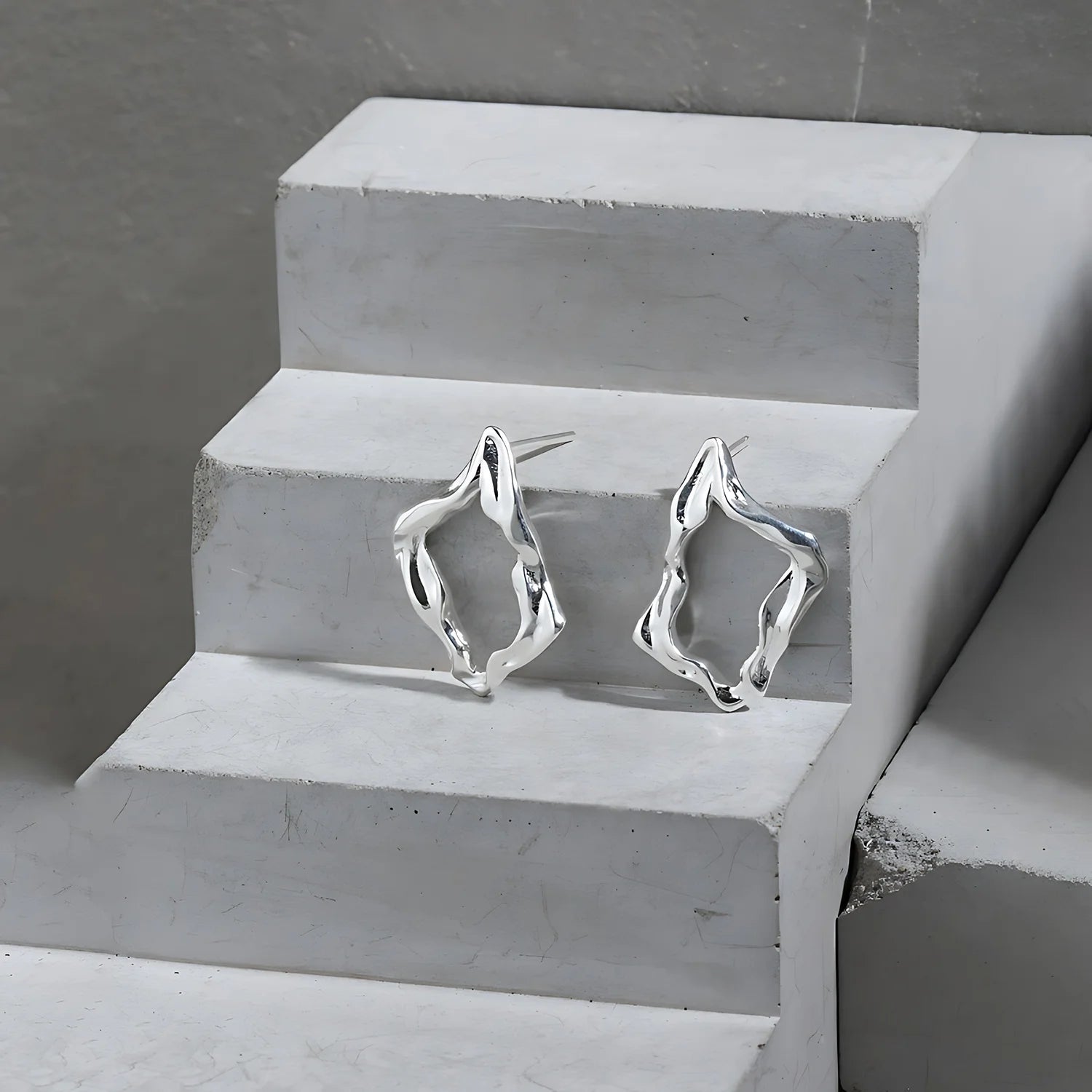 Molten Diamond Hoops, silver, product shot on concrete steps