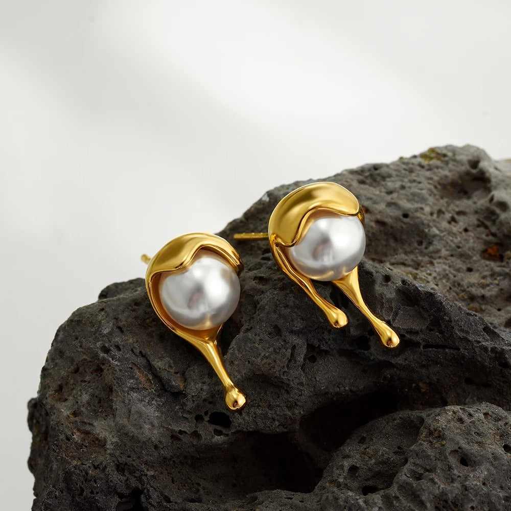 Molten pearl earrings on stone