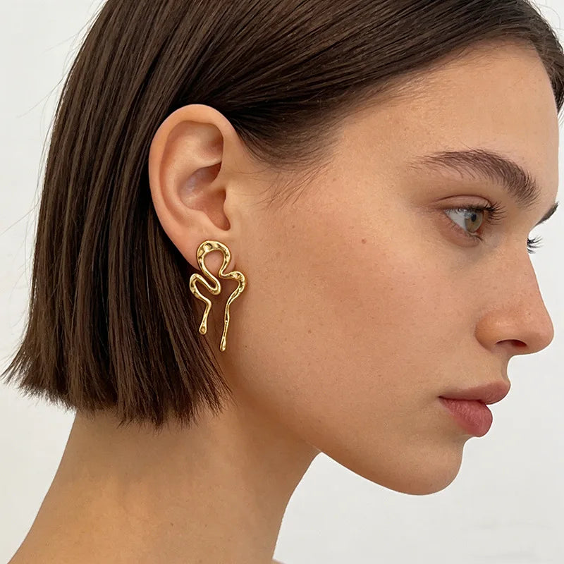 Molten squiggle earrings worn on ear, profile
