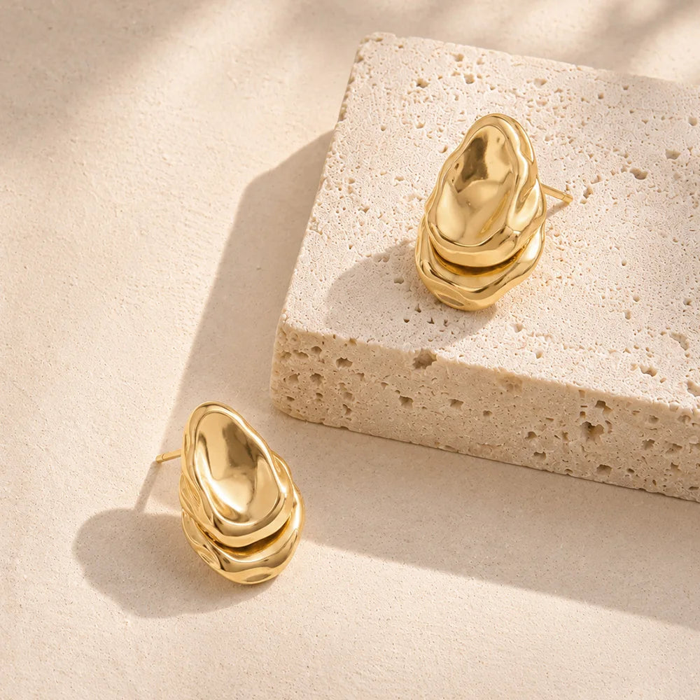 Molten Teardrop Studs, gold, product shot on stone