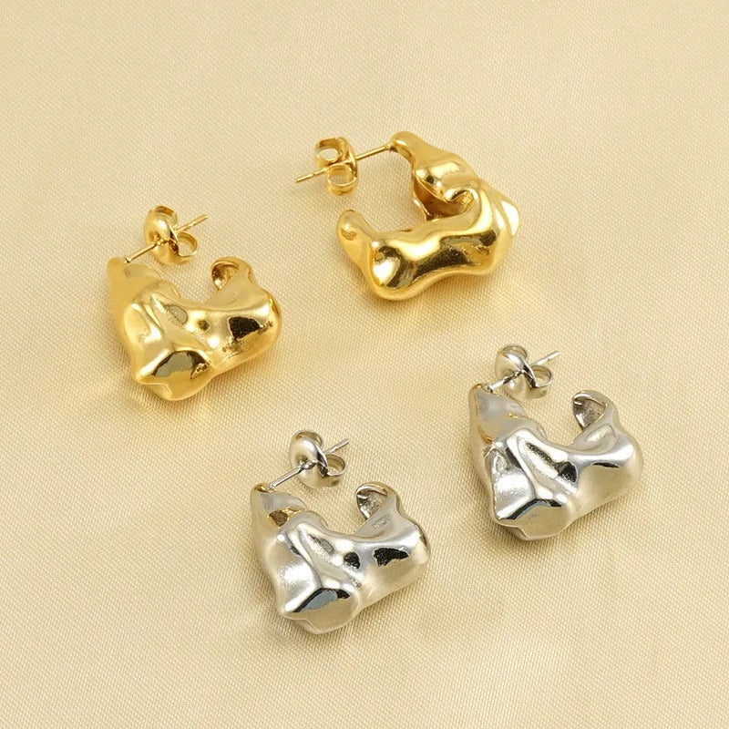 Gold and silver molten textured hoop earrings side by side
