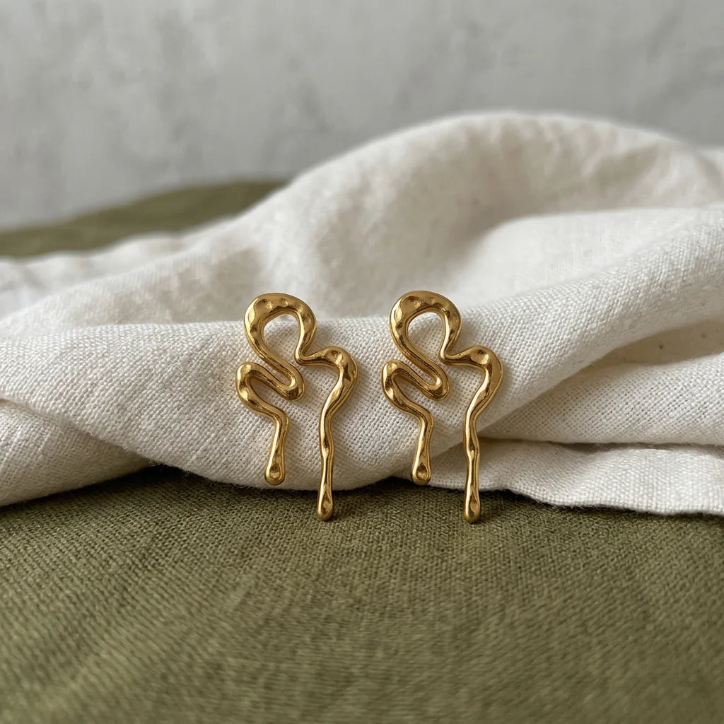 Molten squiggle earrings on fabric