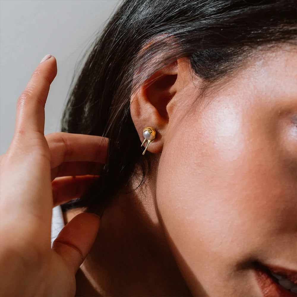 Molten pearl earrings worn in ear